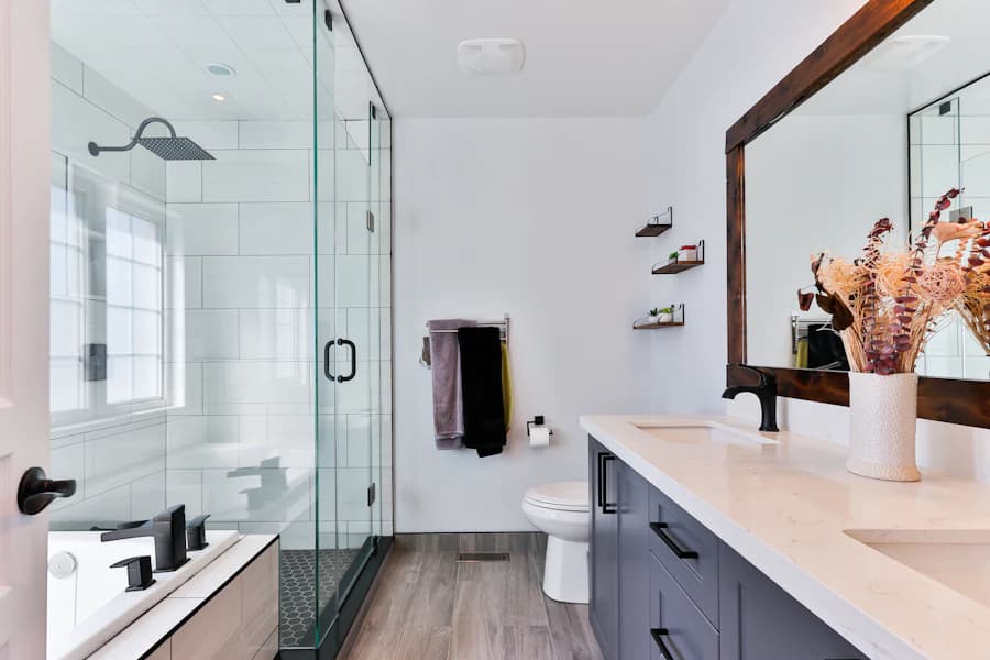 Renovated bathroom with a frameless glass shower and a double vanity.