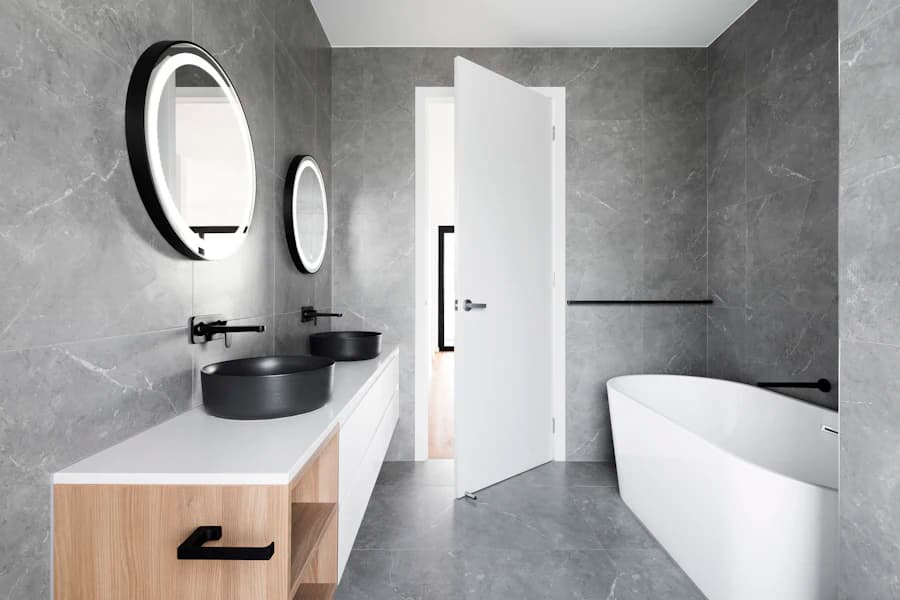 Modern marble bathroom with a freestanding tub and a floating oak vanity.